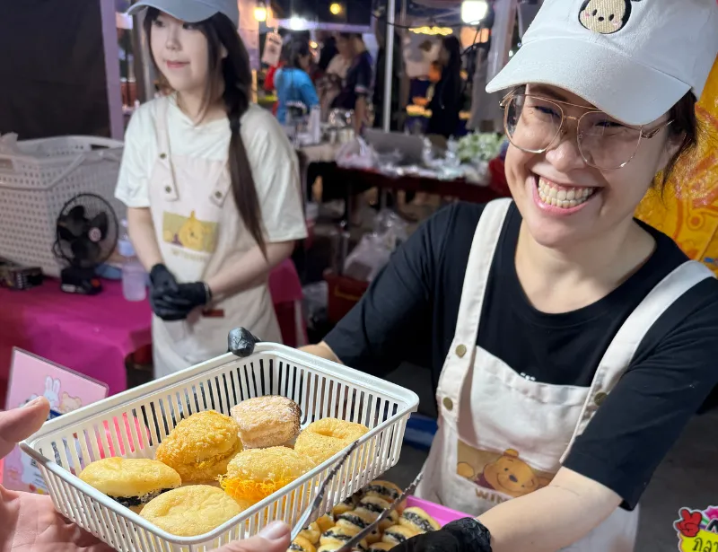 Buying food from a smily street vendor